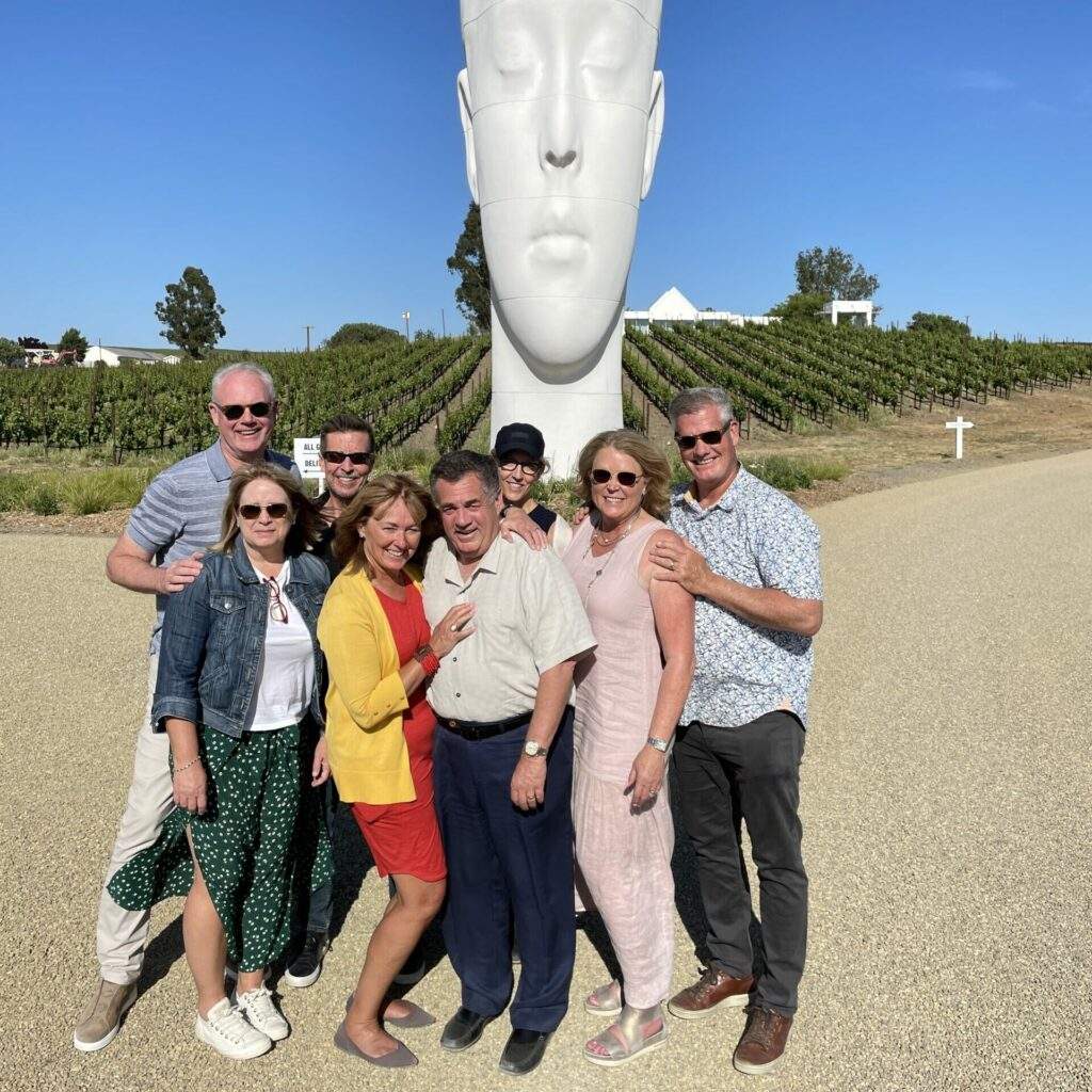 rocky pond group posing in front of the vineyards