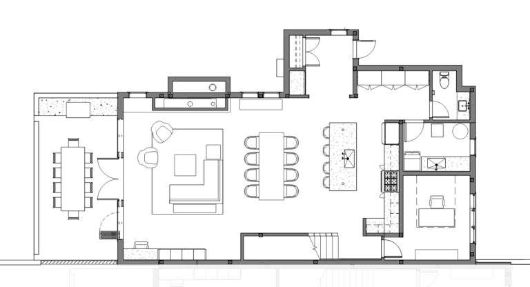 Black and white architectural floor plan showing kitchen, dining area, living room, bedroom, bathroom, and laundry with furniture placement and built-in fixtures indicated—designed to capture stunning vineyard views near Lake Chelan at Rocky Pond Estate.