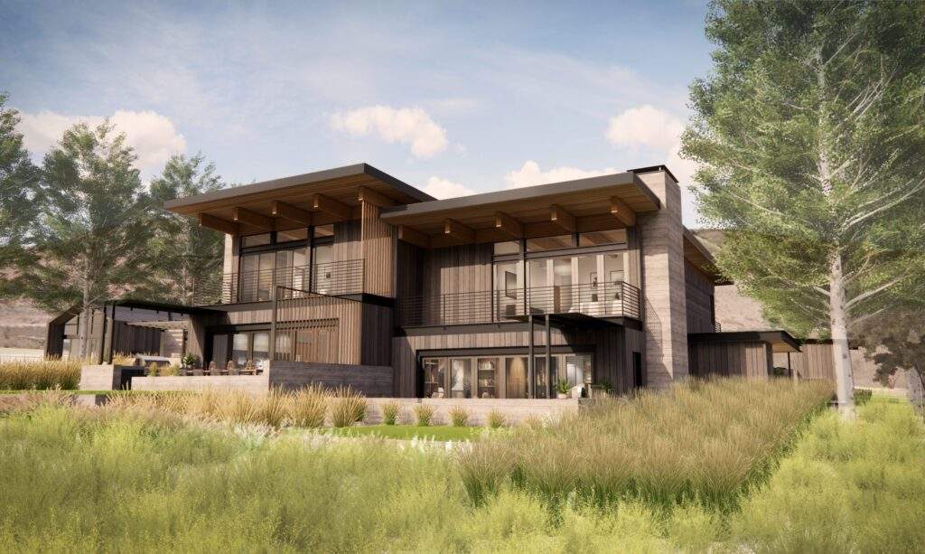 Modern two-story house with large windows, wood and metal accents, sloped roofs, and surrounding landscaped grass and trees under a partly cloudy sky, offering stunning vineyard views at Rocky Pond Estate in North Central Washington.