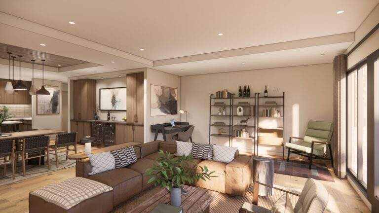Modern living room with brown sectional sofa, shelving unit, armchair, coffee table with plant, and open dining area with pendant lights in the background. Large windows let in natural light and offer beautiful vineyard views near Lake Chelan.