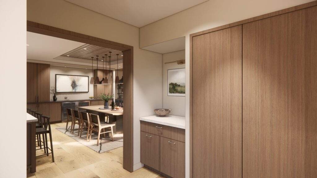 Modern kitchen and dining area with wooden cabinets, a countertop, and a table with chairs; neutral colors and soft lighting complement stunning vineyard views at Rocky Pond Estate in North Central Washington.